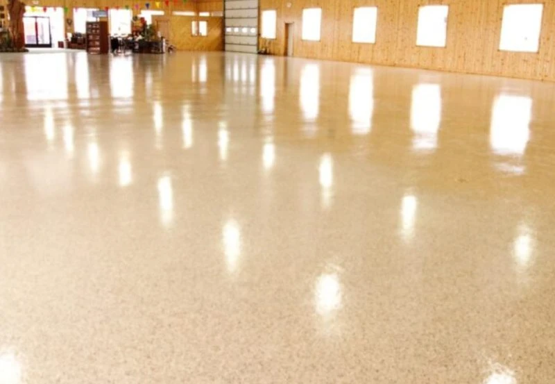 a high-performance commercial flooring system, likely epoxy or polyurea coating, installed in a large space like a warehouse, showroom, or garage.