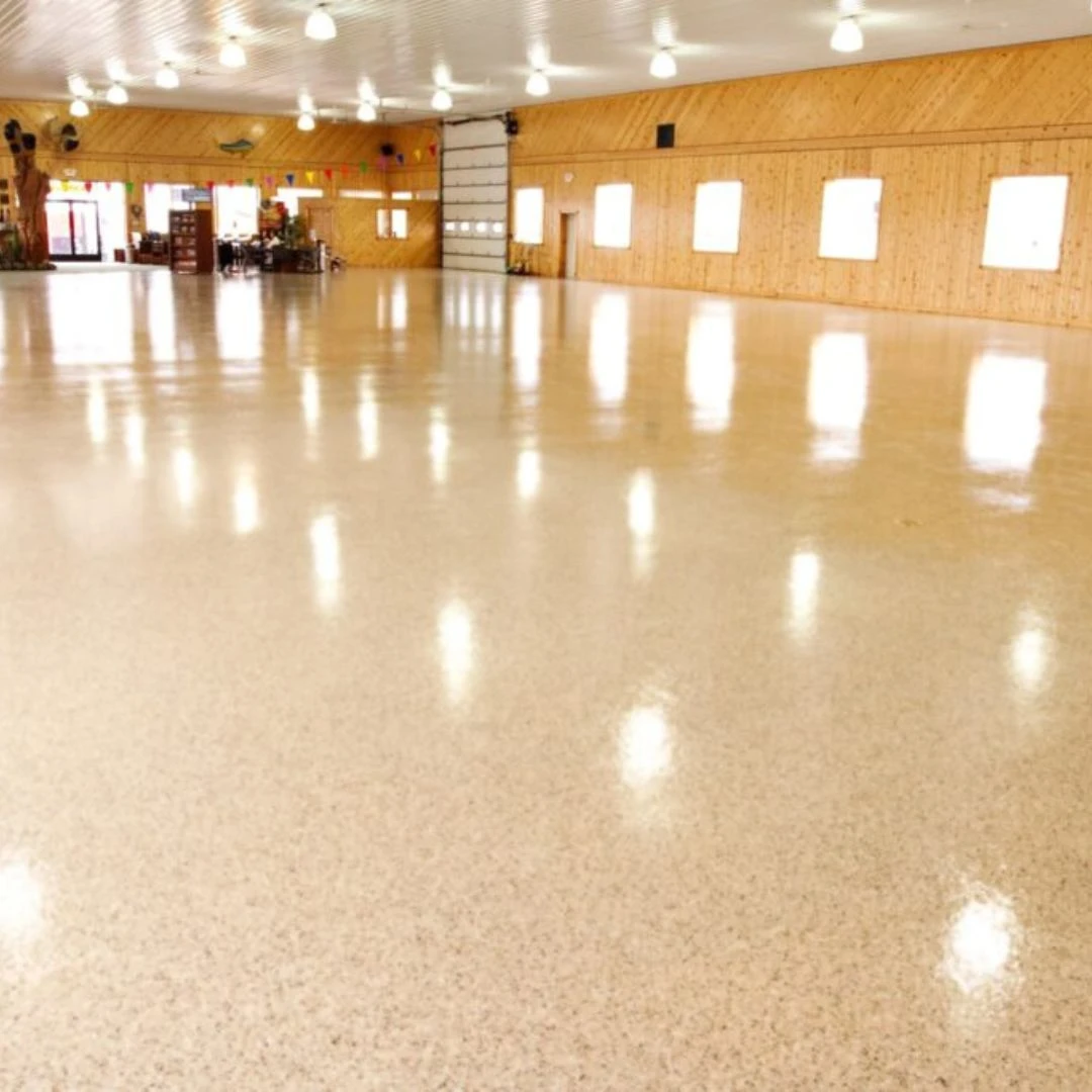 a high-performance commercial flooring system, likely epoxy or polyurea coating, installed in a large space like a warehouse, showroom, or garage.