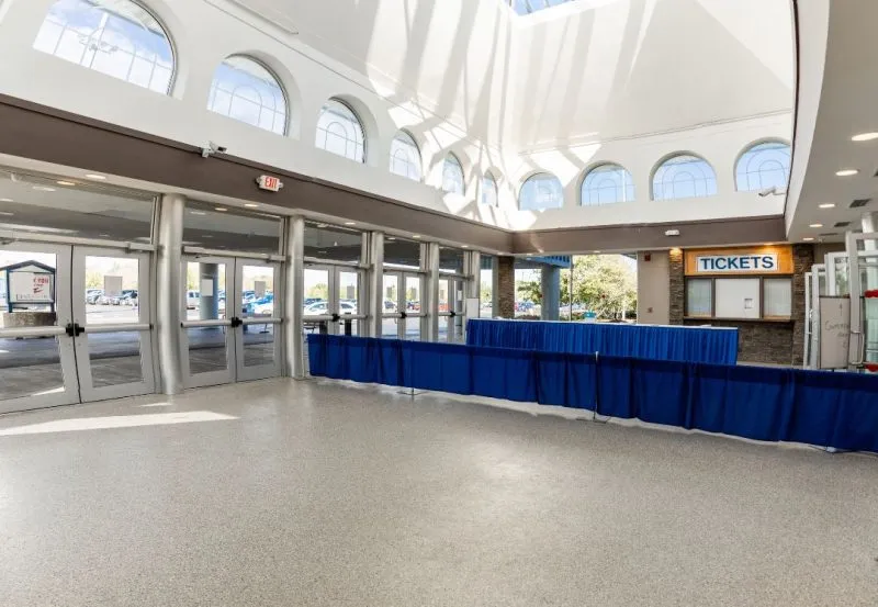 a modern commercial entryway or lobby, likely featuring a professionally installed concrete floor coating.