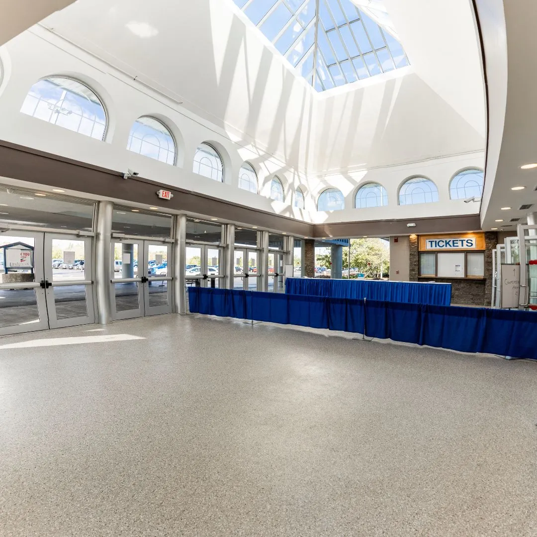 a modern commercial entryway or lobby, likely featuring a professionally installed concrete floor coating.