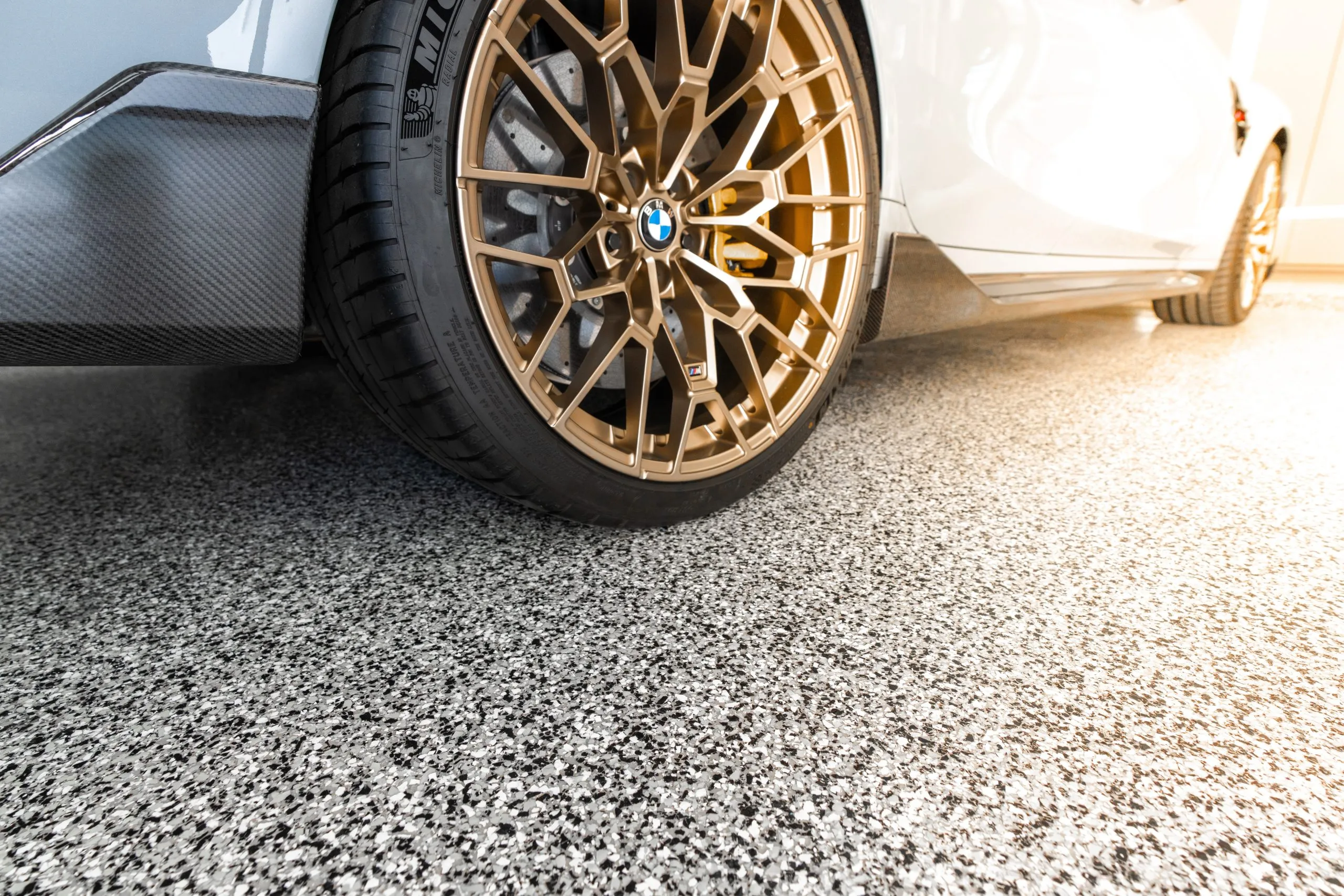 The image displays a white BMW M2 CS.