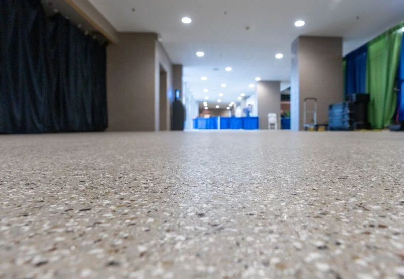 a modern polished concrete or epoxy terrazzo flooring system.