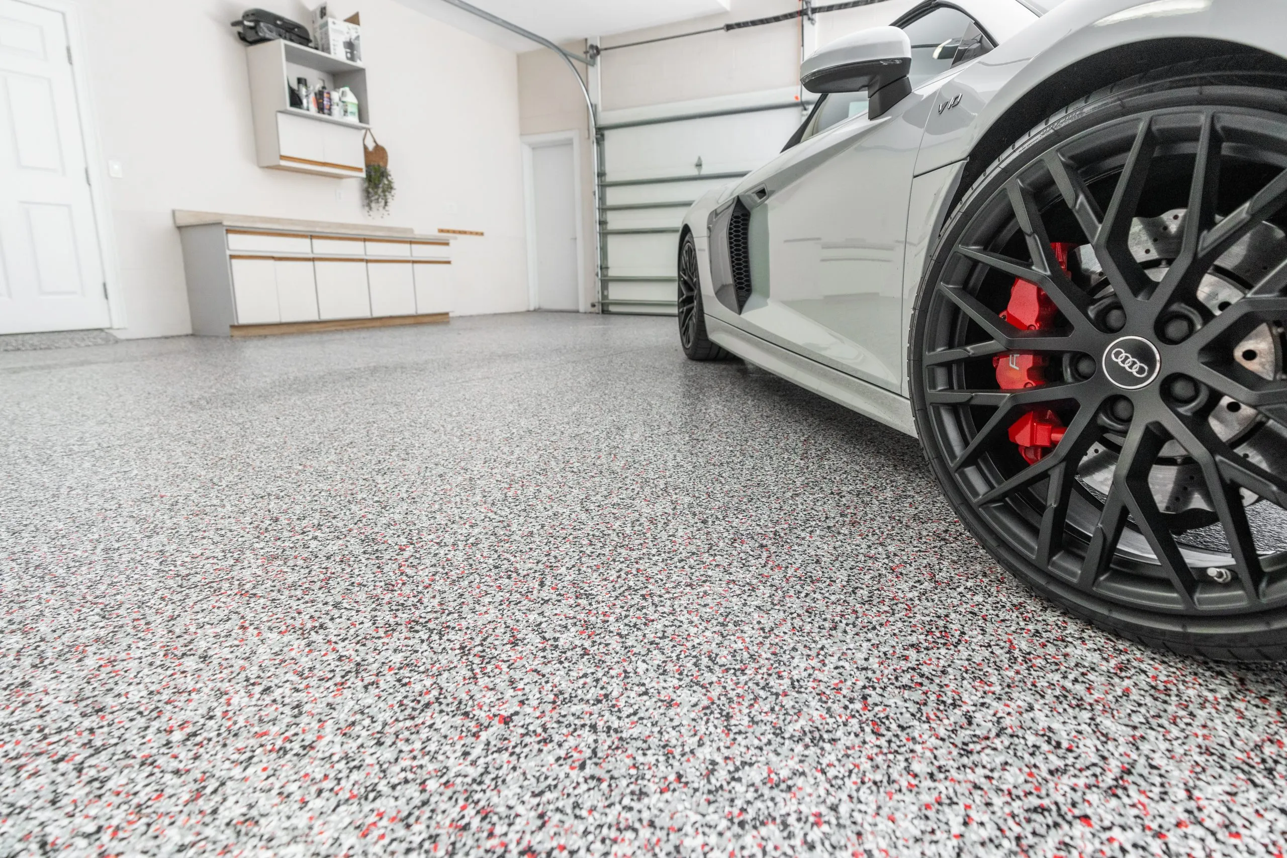 a decorative epoxy floor coating with vinyl chip flakes, commonly installed in garages for durability and aesthetic appeal.