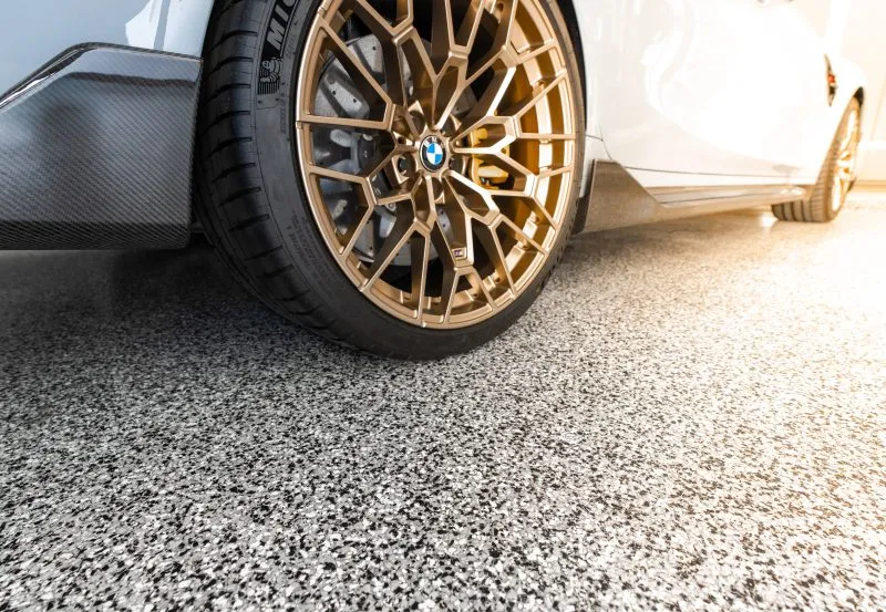 a high-performance BMW vehicle, likely the M2 CS, equipped with custom bronze-finished alloy wheels.