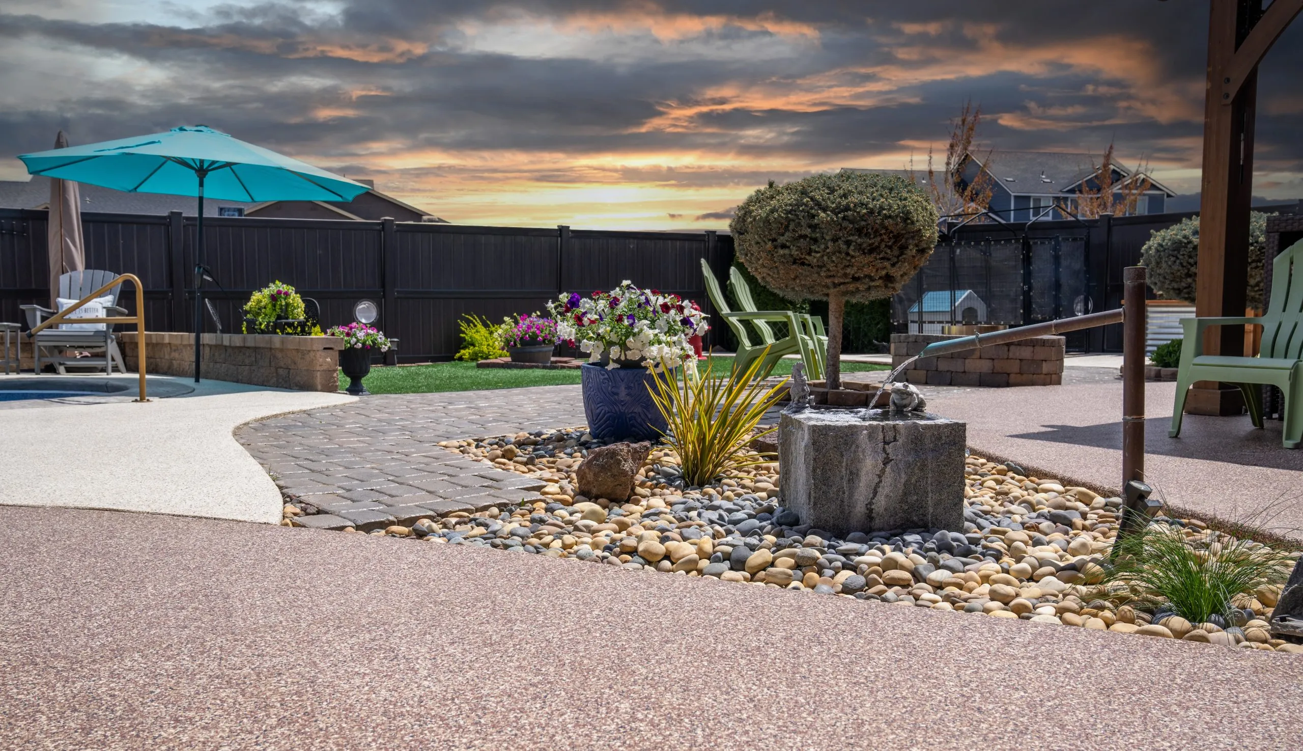 a professionally landscaped patio featuring a modern polyurea concrete coating, designed for durability and a granite-like appearance.