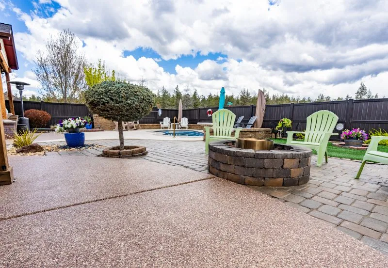 a professionally coated residential patio area, likely featuring a decorative polyurea or epoxy finish designed for durability and UV resistance.