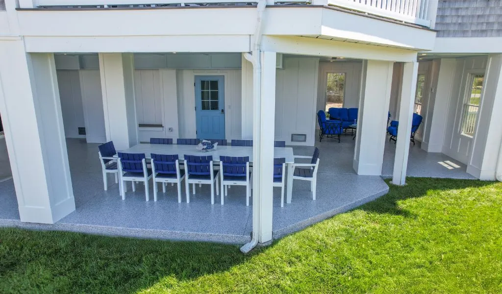 an outdoor patio area with concrete flooring that has been coated with a durable, light-colored material.