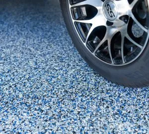 tire on top of garage floor coating that stands up to heavy objects and repels tire marks